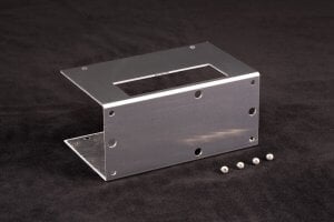 Three-quarter view of optional mounting bracket for CP-040HT. Attaches to CP-040 HT to lift the CP-040HT air intake away from a mounting surface. Has mounting holes so bracket can be attached to common optical tables and other mounting surfaces.